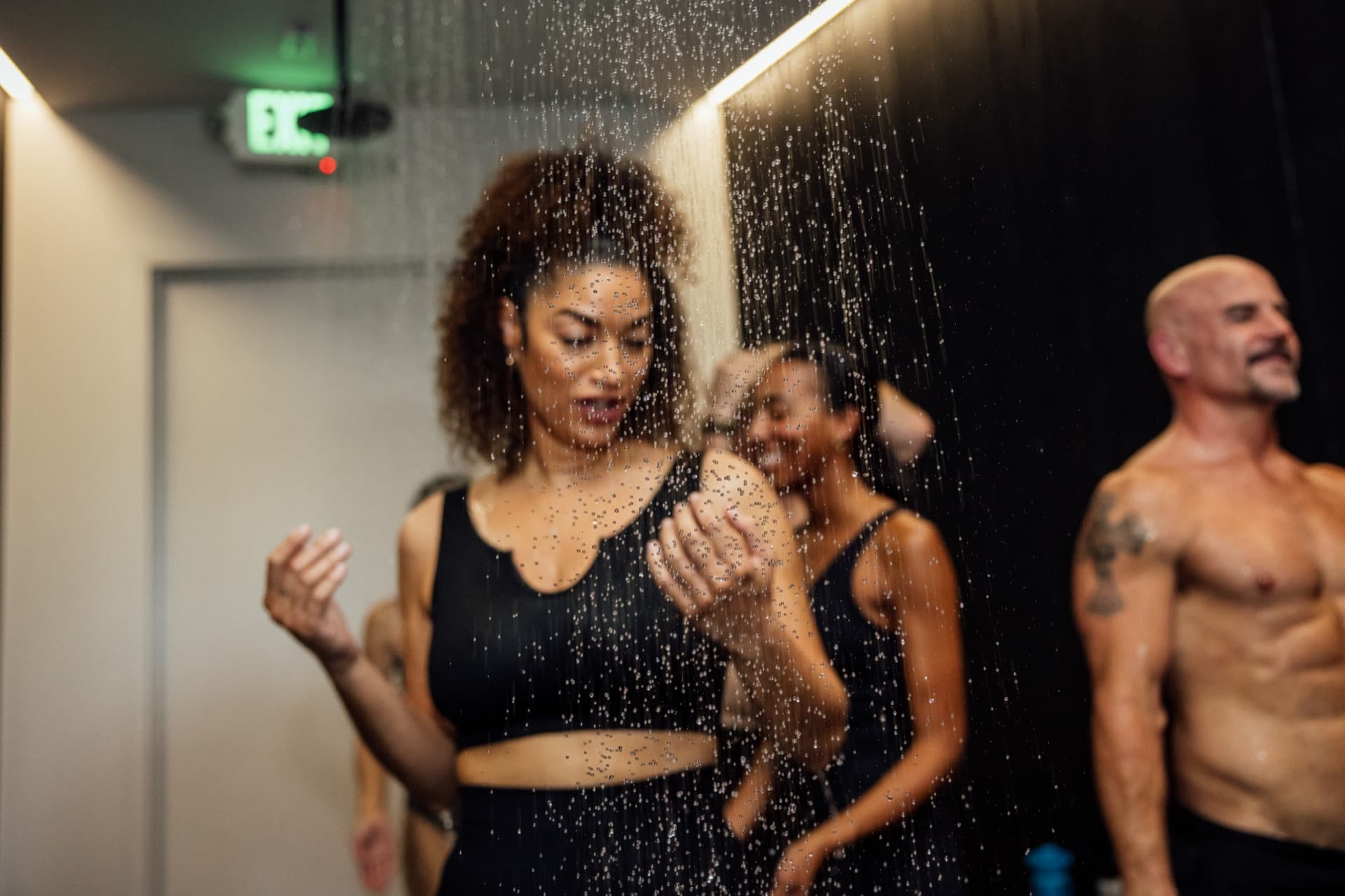 Group in rain shower between sauna rounds